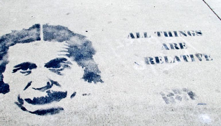 A print of Einstein's face on pavement with the words "All things are relative" stamped nearby