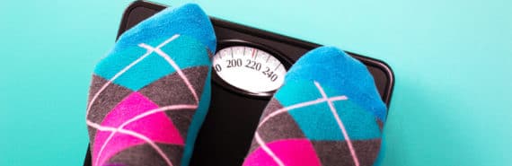 feet in argyle socks on bathroom scale