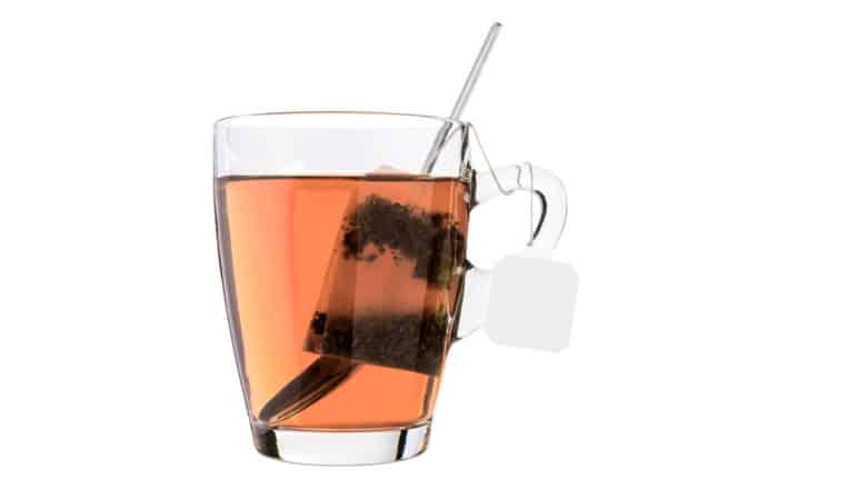 teabag and spoon in glass mug