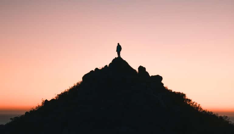 person on mountain in silhouette