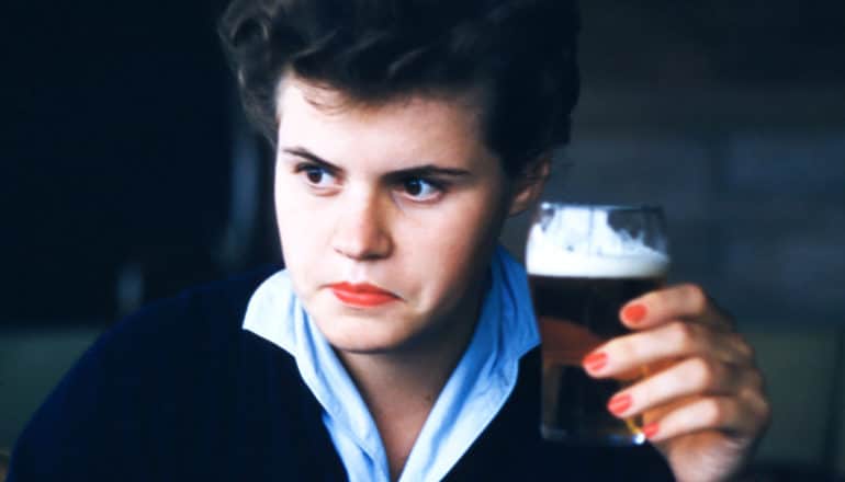 1950's person holding beer stares intensely