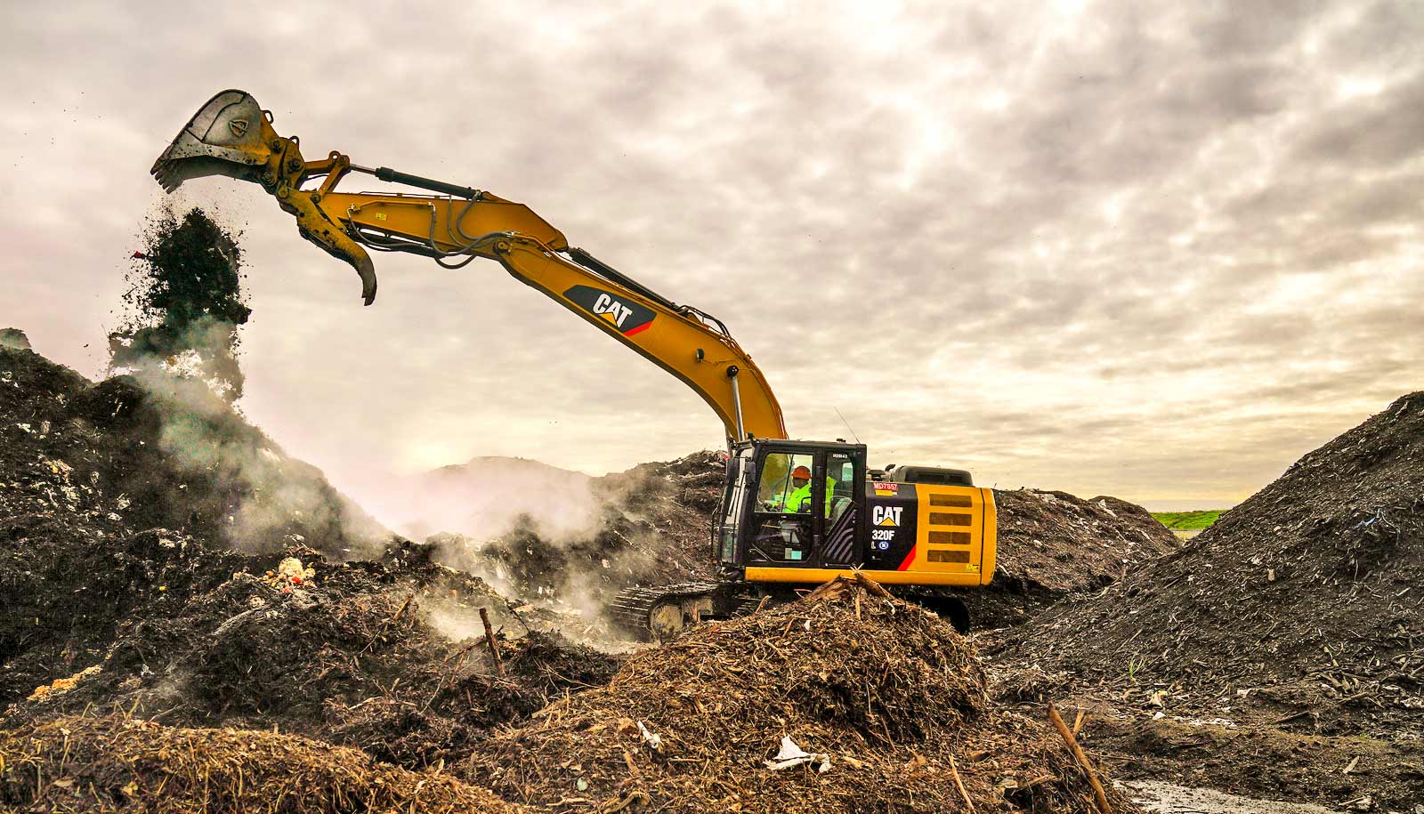 food waste falls from bucket of excavator