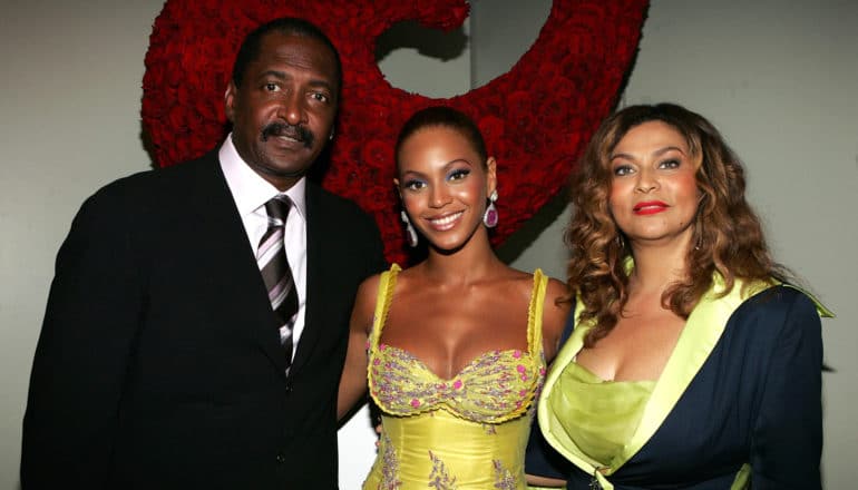 Beyonce stands between her parents