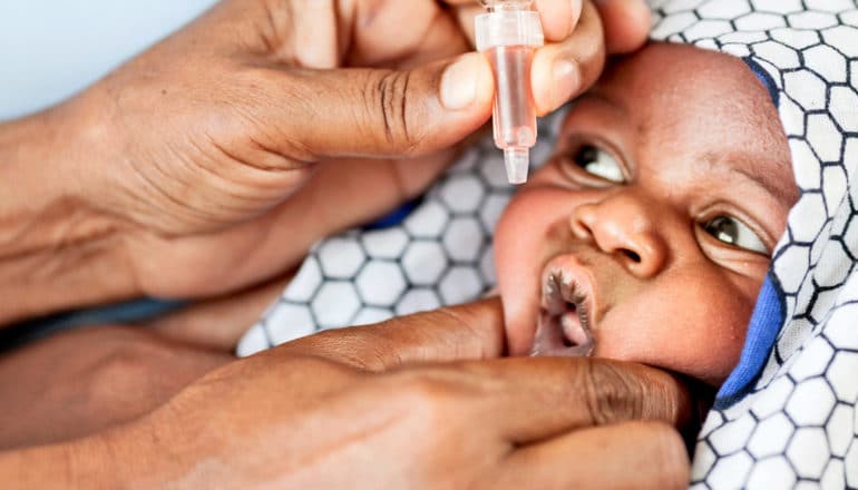 baby receives oral vaccine