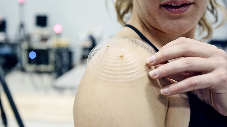 The sensor patch sits on a researcher's shoulder