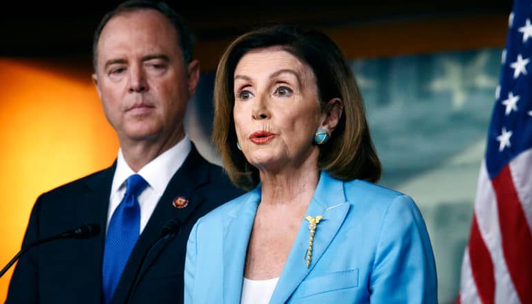 Schiff looks at Pelosi, who's raising her eyebrows and pursing her lips