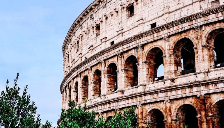 The Colosseum in Rome against a blue sky