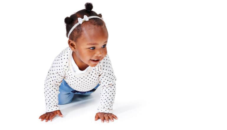 milestones: smiling baby crawls on white background