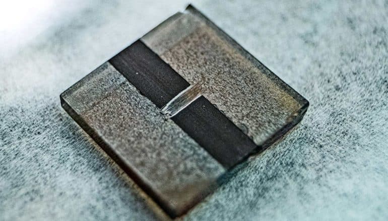 The perovskite solar cell is a small metal-looking square with a dark stripe down its center