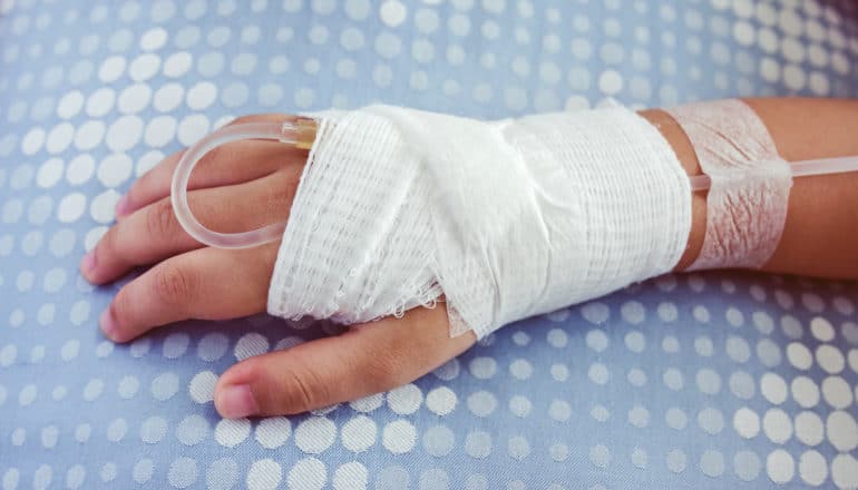 IV in child's bandaged hand