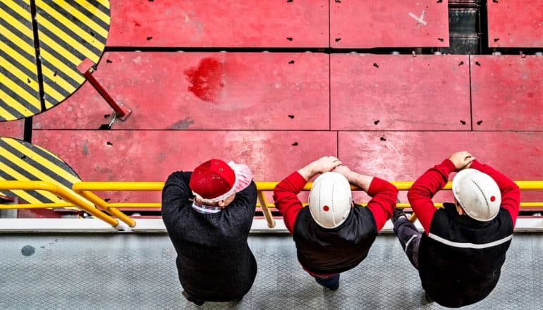 three people in hard hats from above