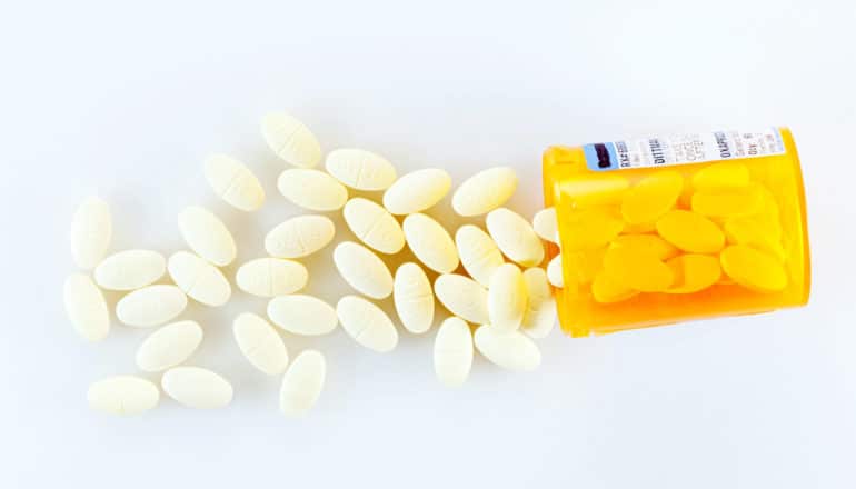 pills spill from prescription bottle