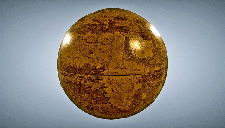 The Hunt-Lenox Globe is brown and tan, sitting against a blue background with Africa showing