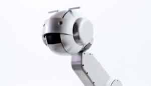 Shimon stands against a white backgorund. The robot has a long "neck" with a round "head"