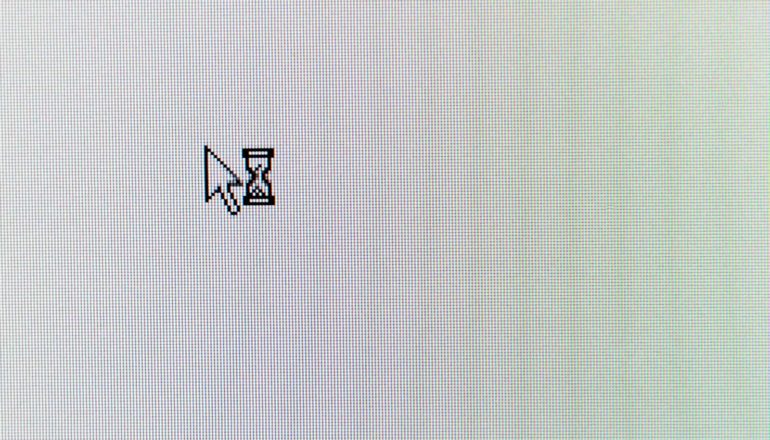 cursor arrow and hourglass on blank computer screen