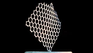 A 3D-printed object with a honeycomb structure on a black background
