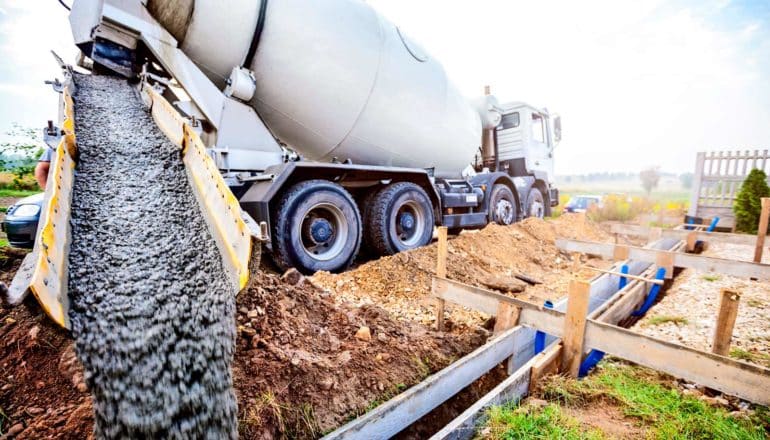 cement mixer pours concrete at building site