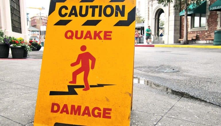 A sign reads "Caution: Quake Damage"