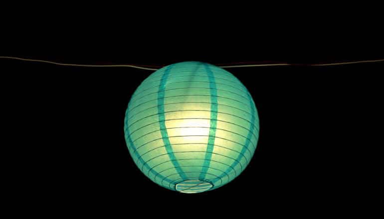 glowing green paper lamp on wire