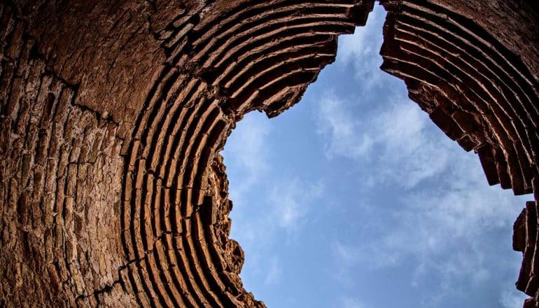 sky through jagged hole in stone structure