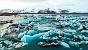 Arctic sea ice looks bright blue in the water