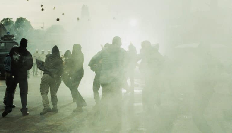 people throwing rocks in fog