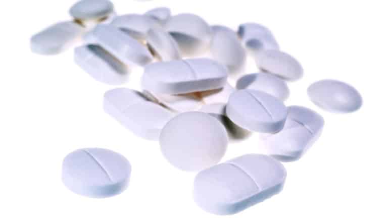white pills on white surface