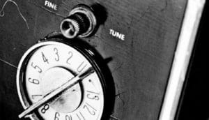 A dial has the words "fine tune" above it on an old machine