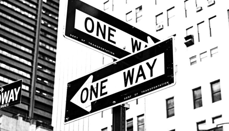 Two "One Way" road signs point in different directions