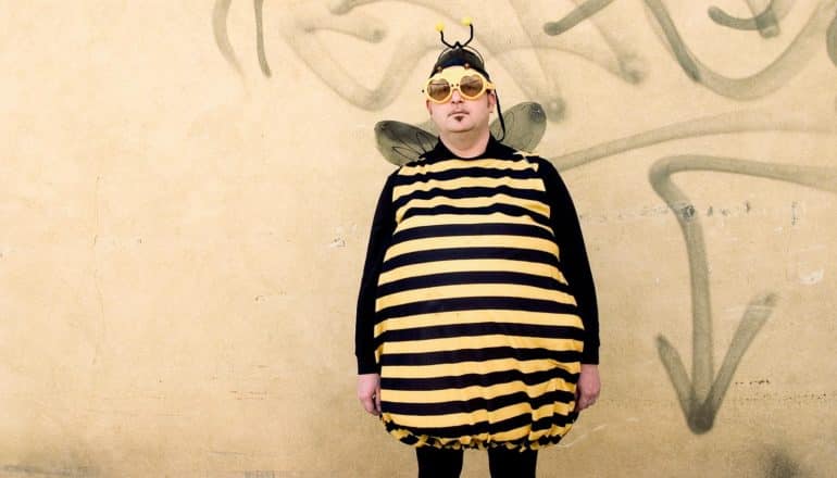 serious adult in bee costume