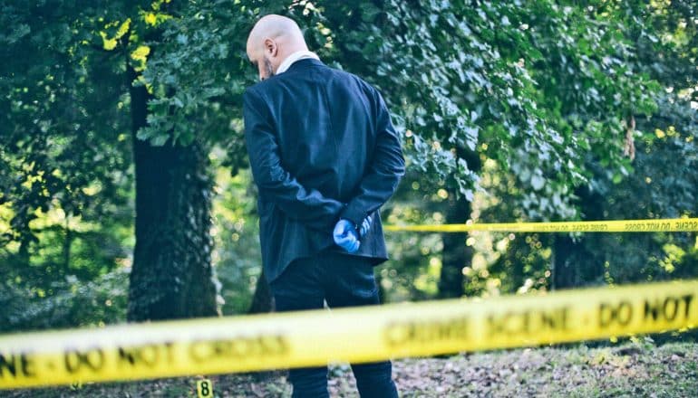 person in suit at crime scene