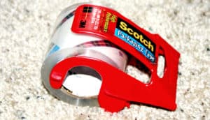 A roll of tape sits on carpet