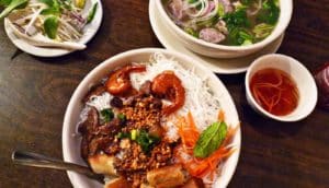bowls of pho and condiments