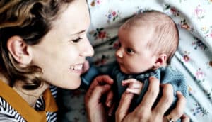 A mom and baby look at each other