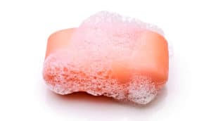A pink bar of soap on a white background