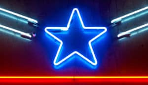 A blue neon star in the dark