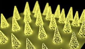 An illustrated close-up of the microneedles on the patch, which show up yellow against a black background