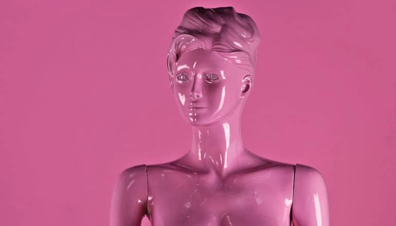 female-looking mannequin covered in pink paint