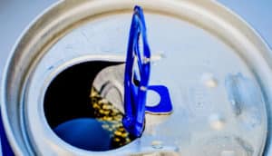 An open energy drink can with the tab pointing up