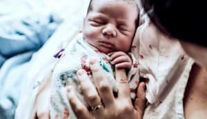 A mother holds her newborn