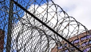 A barbed wire fence around a prison