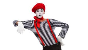 A mime with a red beret leans on an invisible object