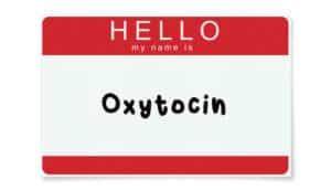 sticker nametag says "HELLO My name is" with "oxytocin" written below