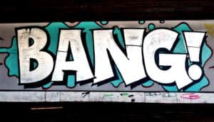 Graffiti of the word "Bang!" on a concrete wall in large white letters