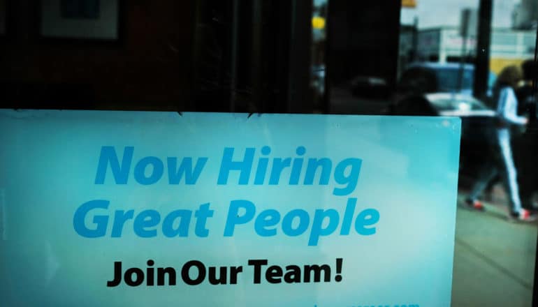 sign in dark window says "now hiring great people join our team!"