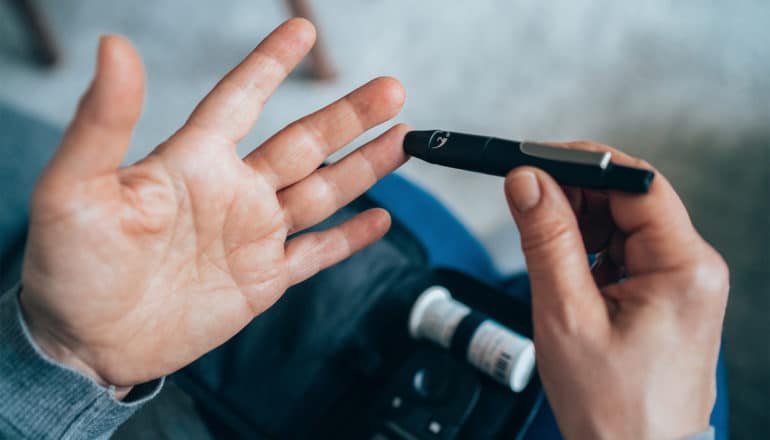 A person tests their blood sugar