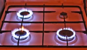 A gas stove with three out of four burners turned on