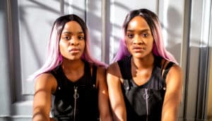 serious ,seated identical twins