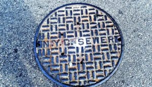 A manhole cover of a New York sewer reads "NYC Sewer"
