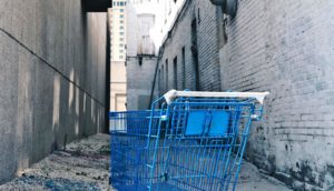 blue shopping cart in alley